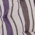 Close-up of padded cushion fabric with vertical stripes in dark purple and brown tones