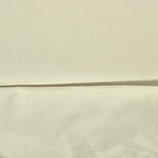 Close-up of textured beige Oxford fabric with a stitched seam