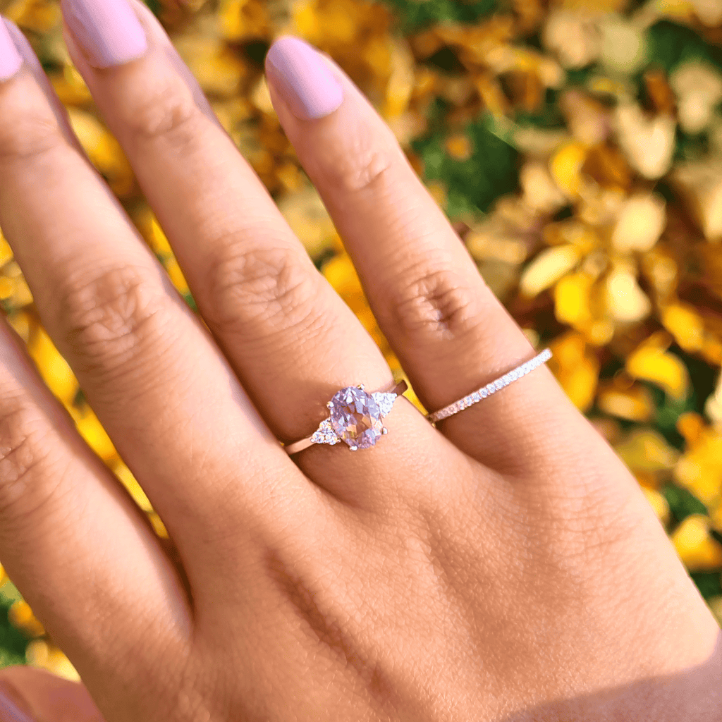 Sterling silver ring with small oval lavender gemstone and prong-set diamond band