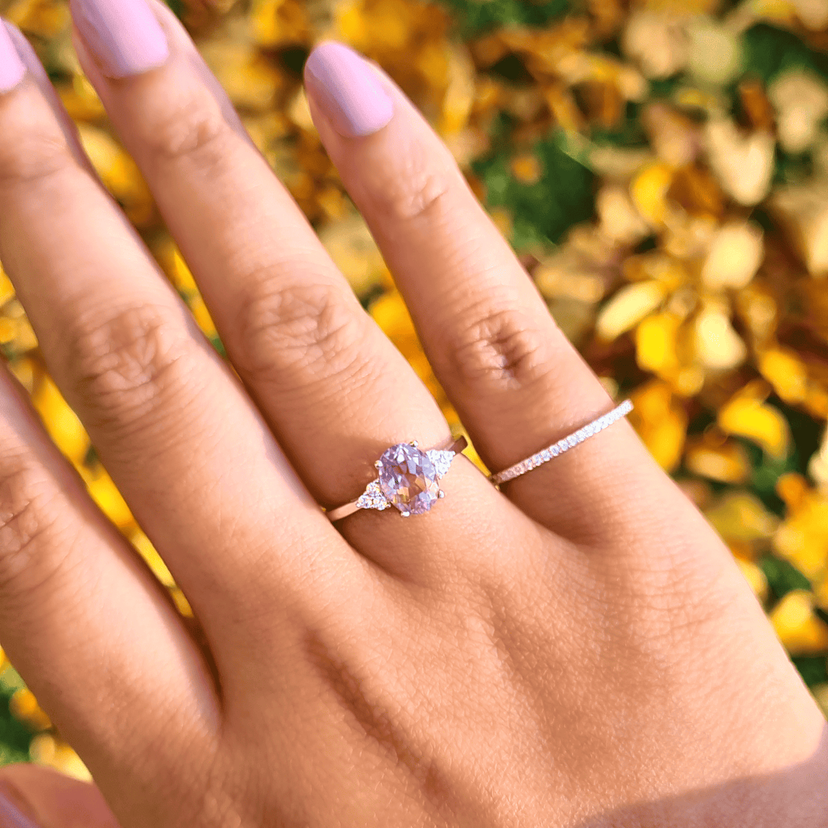 Sterling silver ring with small oval lavender gemstone and prong-set diamond band