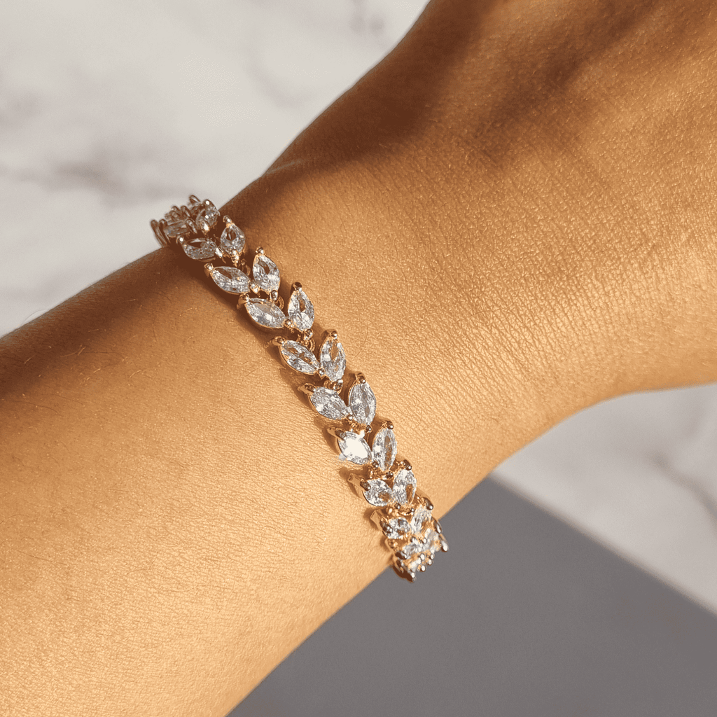 Marquise-cut petal bracelet with oval marquise stones, hinged links, rose-gold tone.