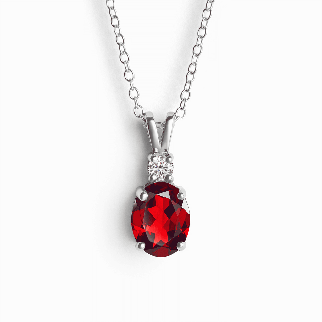 Sterling silver garnet pendant necklace with oval red gemstone and diamond halo accents