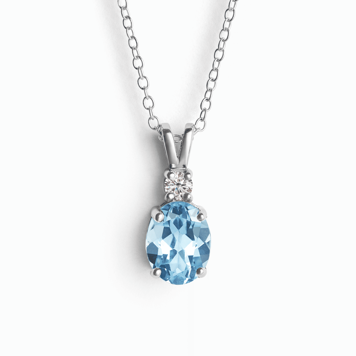 Sterling silver blue topaz pendant necklace with oval gemstone and small halo stones