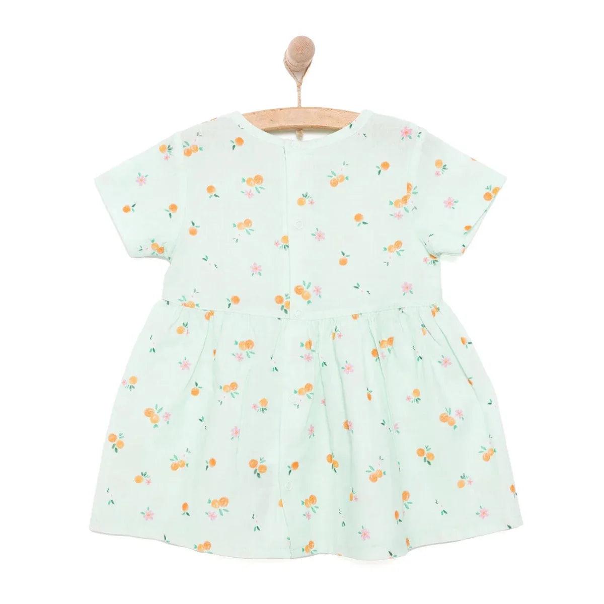 Light blue woven baby dress with allover floral print and pleated skirt