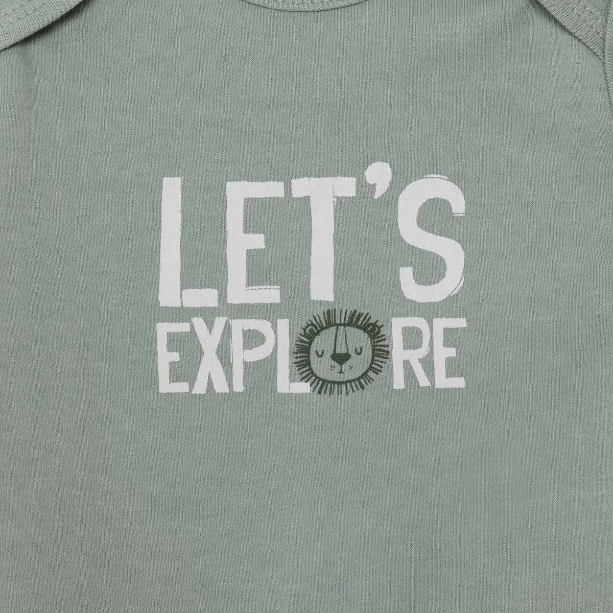 Green bodysuit close-up with “LET’S EXPLORE” lion face graphic