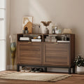Rustic brown shoe cabinet with two closed drawers and shoes stored on the lower shelf