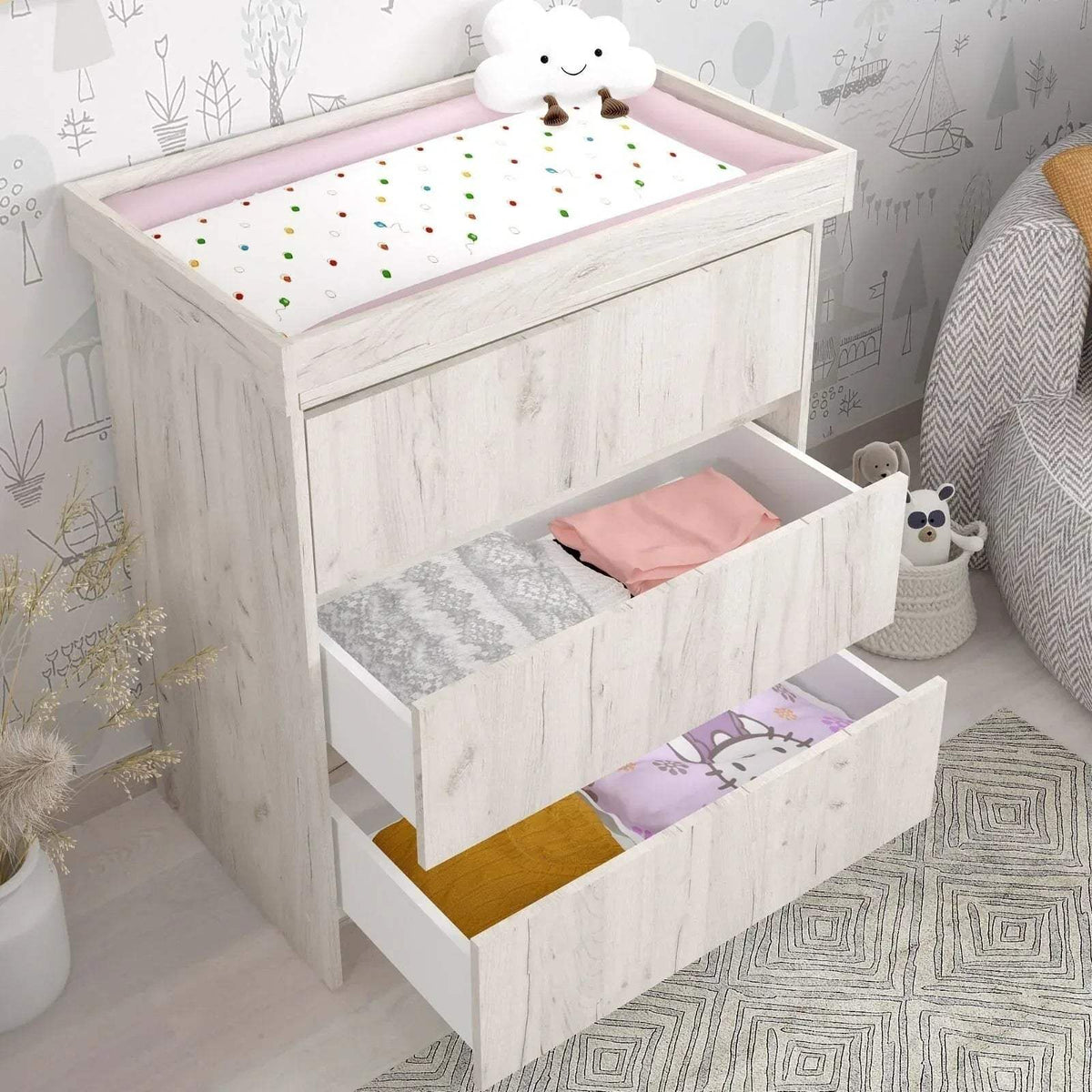 White baby changing unit with open drawer storage and padded changing top surface