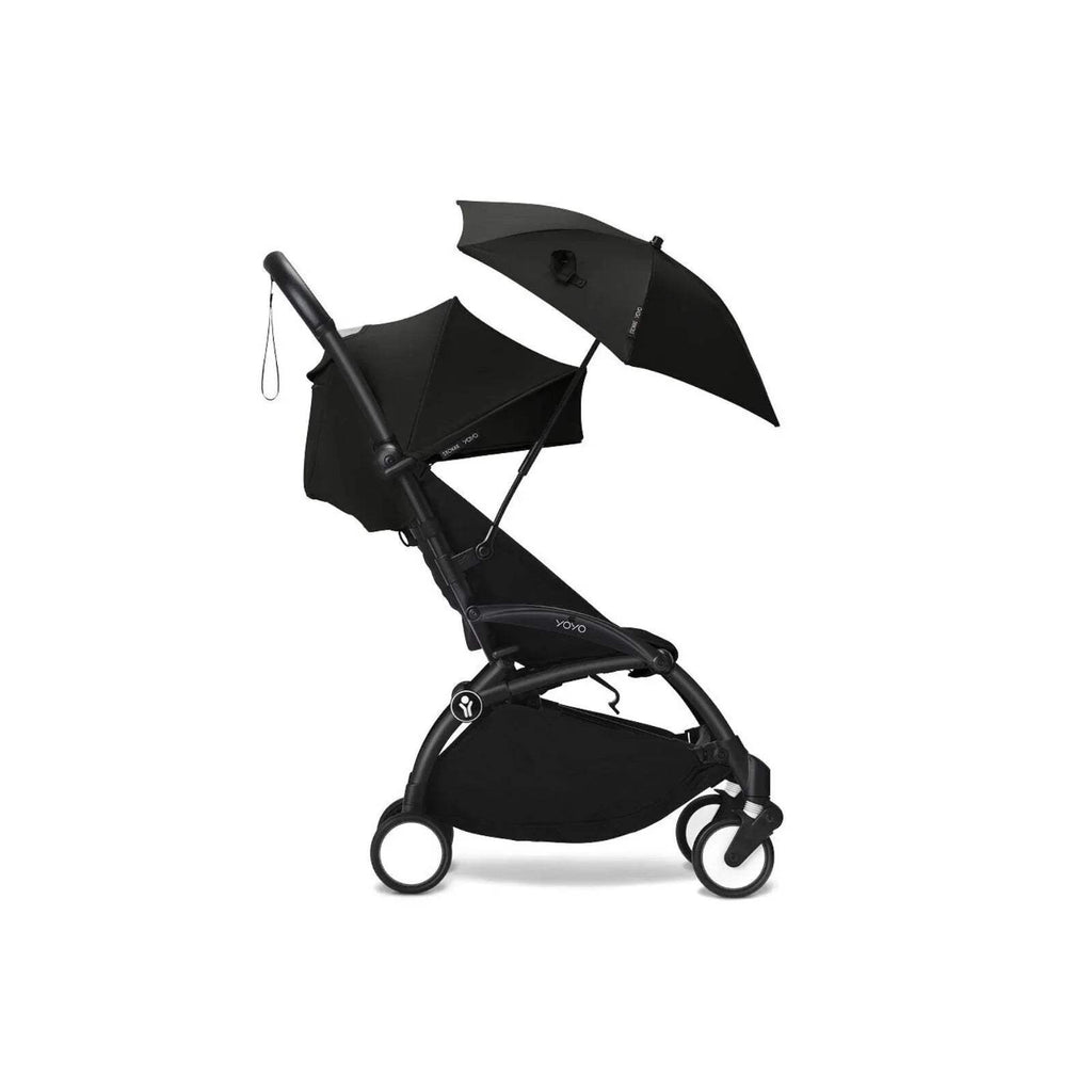 Black stroller parasol on pushchair, open umbrella canopy with folded shade cover