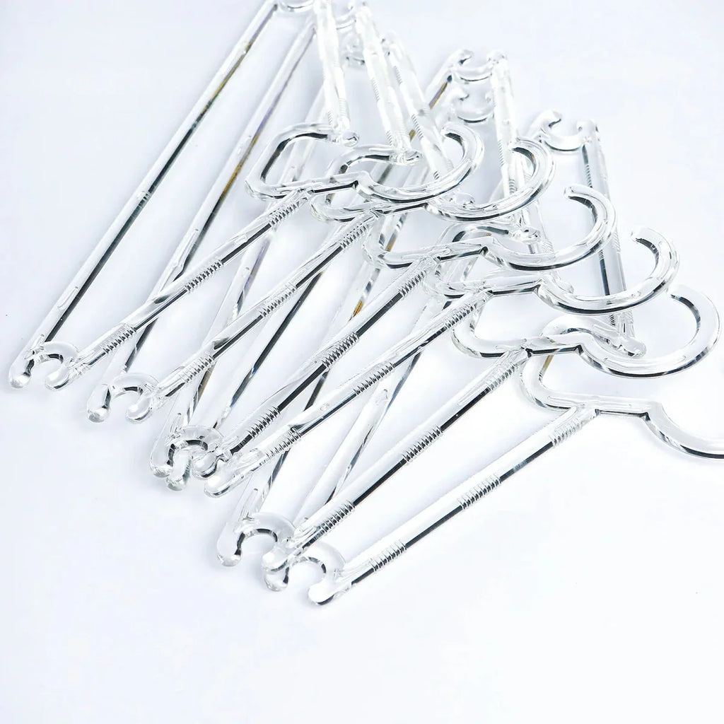 Set of clear plastic baby clothes hangers with curved top hooks and grips