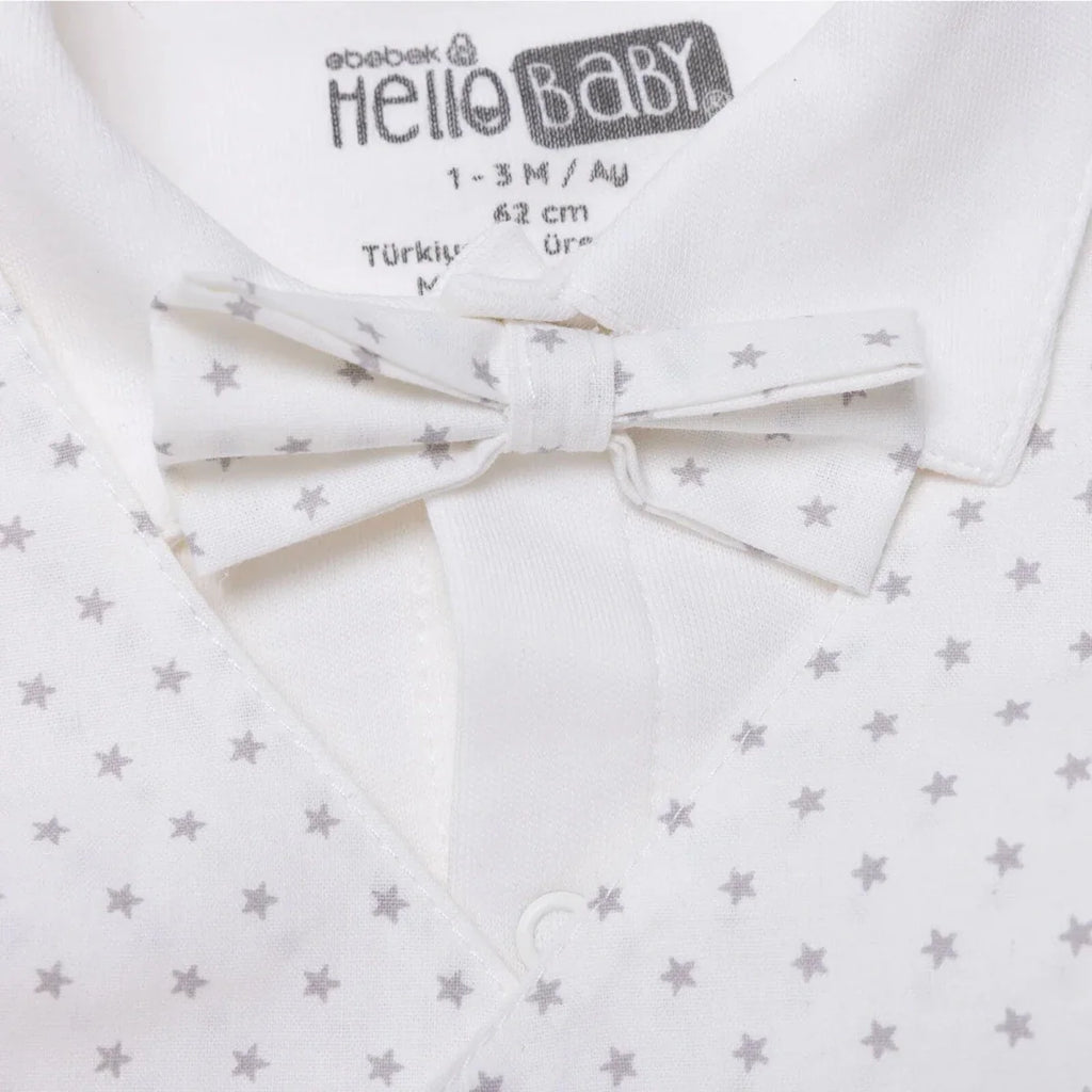 White collared baby outfit with star-printed bow tie at neckline