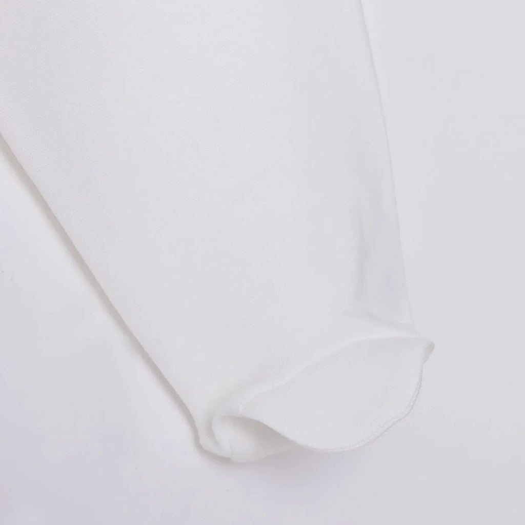 White baby pant leg with soft folded cuff at the ankle