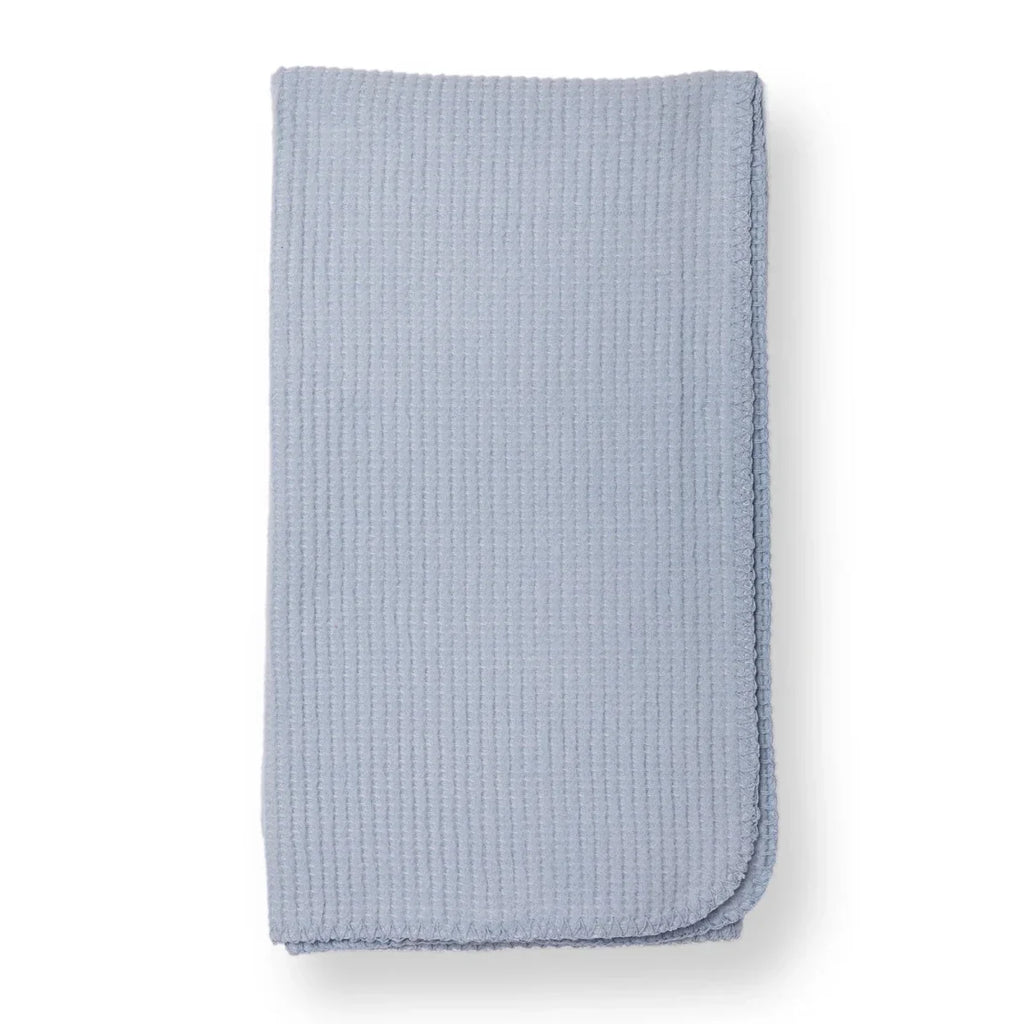 Blue waffle-knit baby blanket with stitched edge, folded into a rectangle