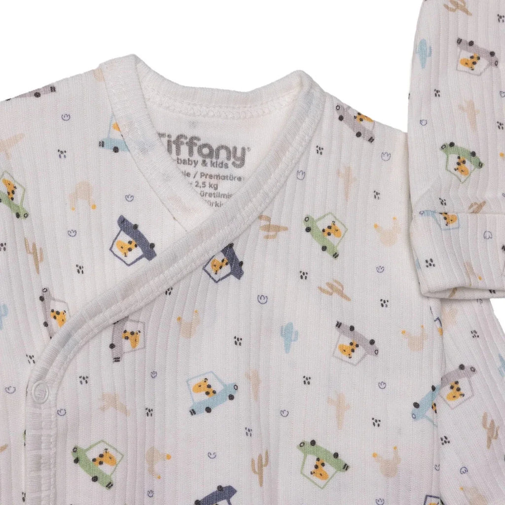 Printed wrap-neck baby top with small animal and robot motifs on an ecru base