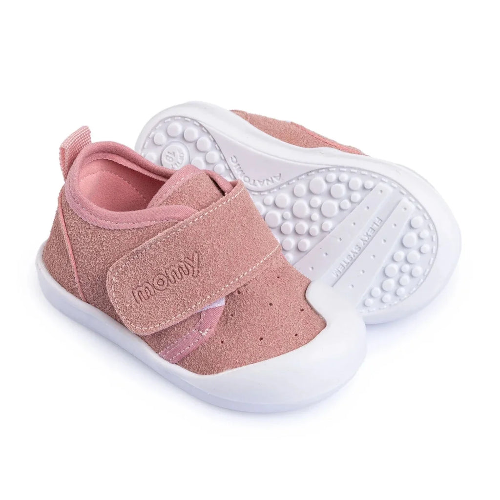 Pink baby shoes with velcro strap, textured grip outsole, and white sidewalls