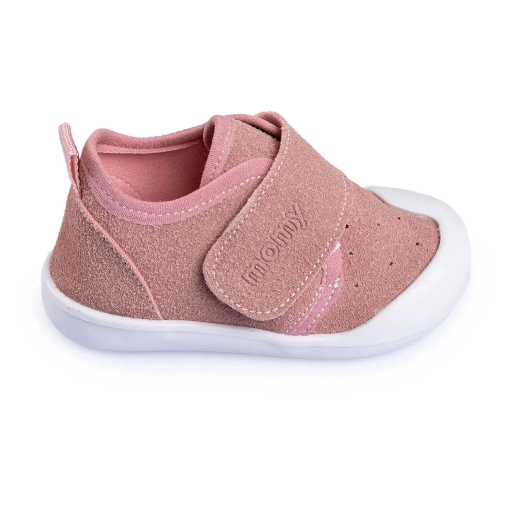 Pink baby shoes with hook-and-loop strap, low profile white sole, and faux leather finish