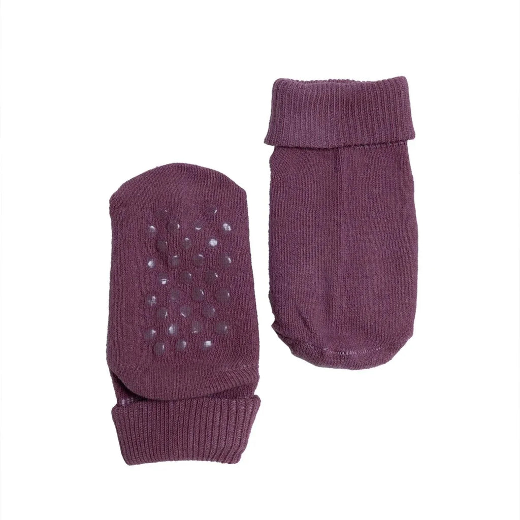 Dark purple roll-top baby socks with small dot pattern on the toe