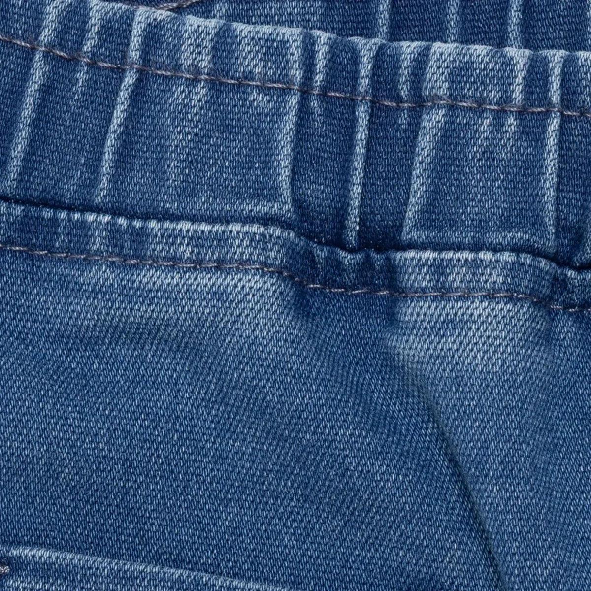 Indigo denim trousers waistband close-up with elastic seam and stitching