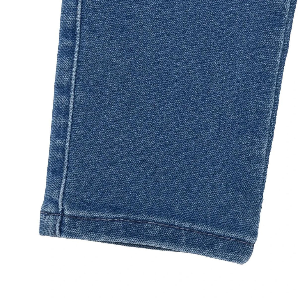 Indigo denim baby trousers with folded hem and side seam stitching detail