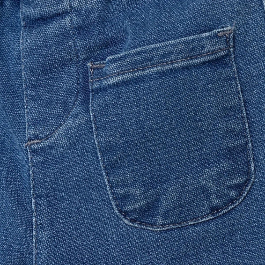 Indigo denim trousers pocket close-up with curved stitched pocket opening