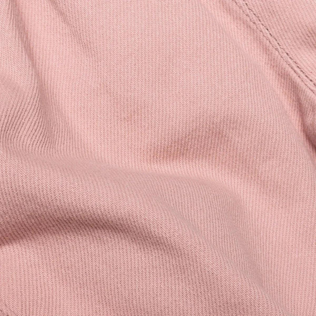 Pink baby trousers fabric close-up with fine woven texture