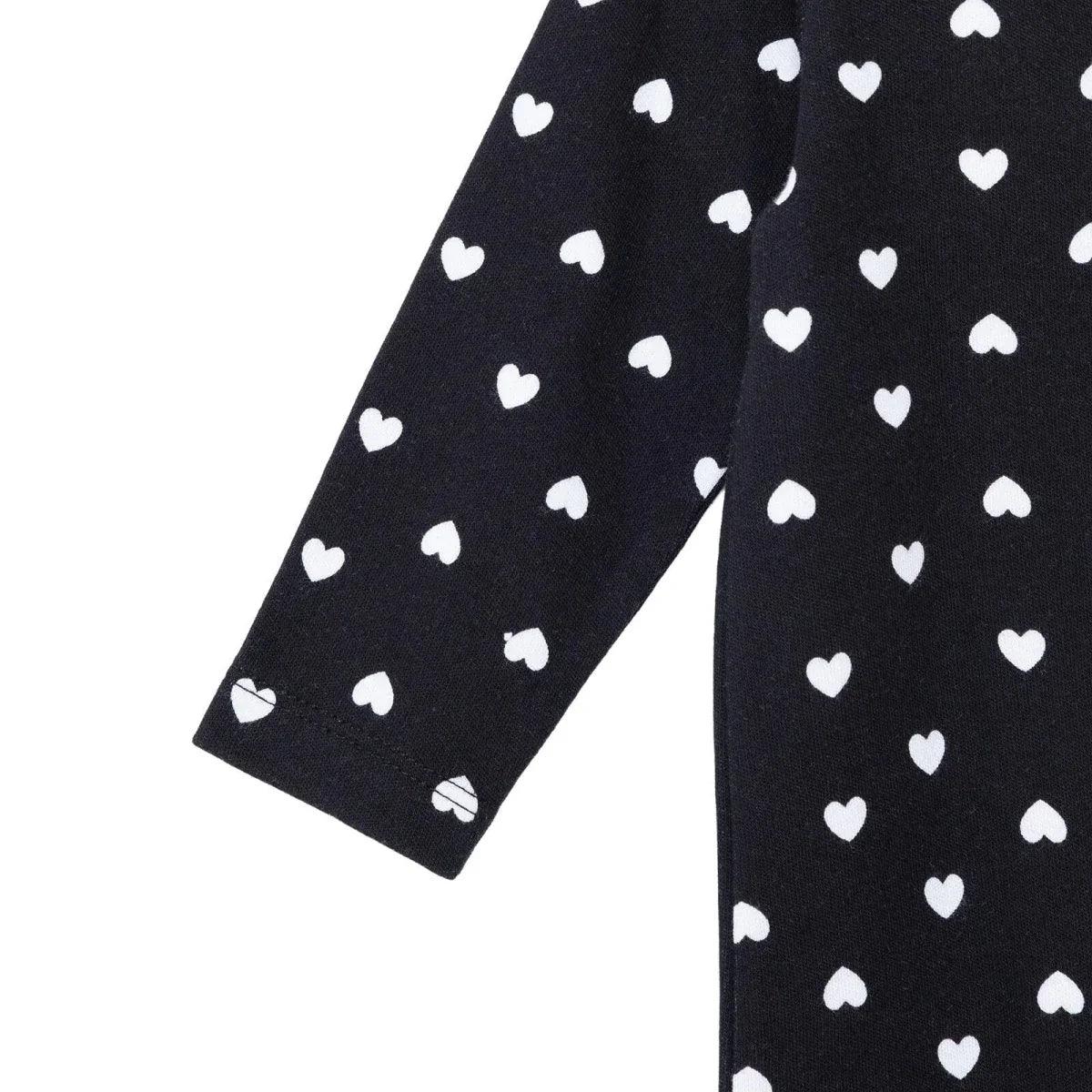 Black baby sleepsuit pant leg with foot opening, white heart print