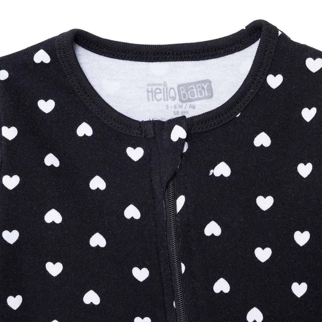 Black baby sleepsuit neckline and chest close-up, white heart print, front zipper