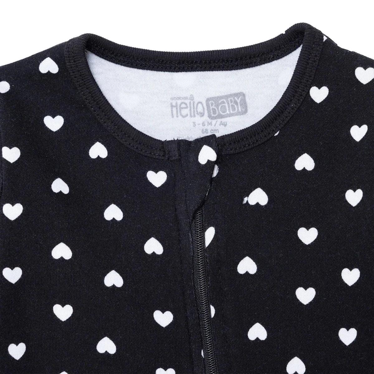 Black baby sleepsuit neckline and chest close-up, white heart print, front zipper