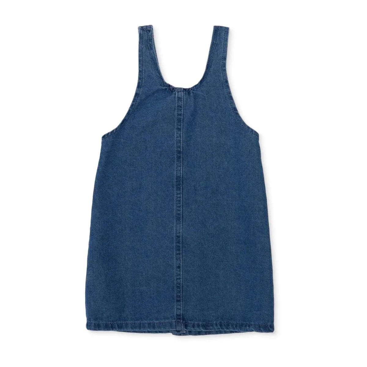 Indigo denim pinafore dress front view with wide straps and curved neckline