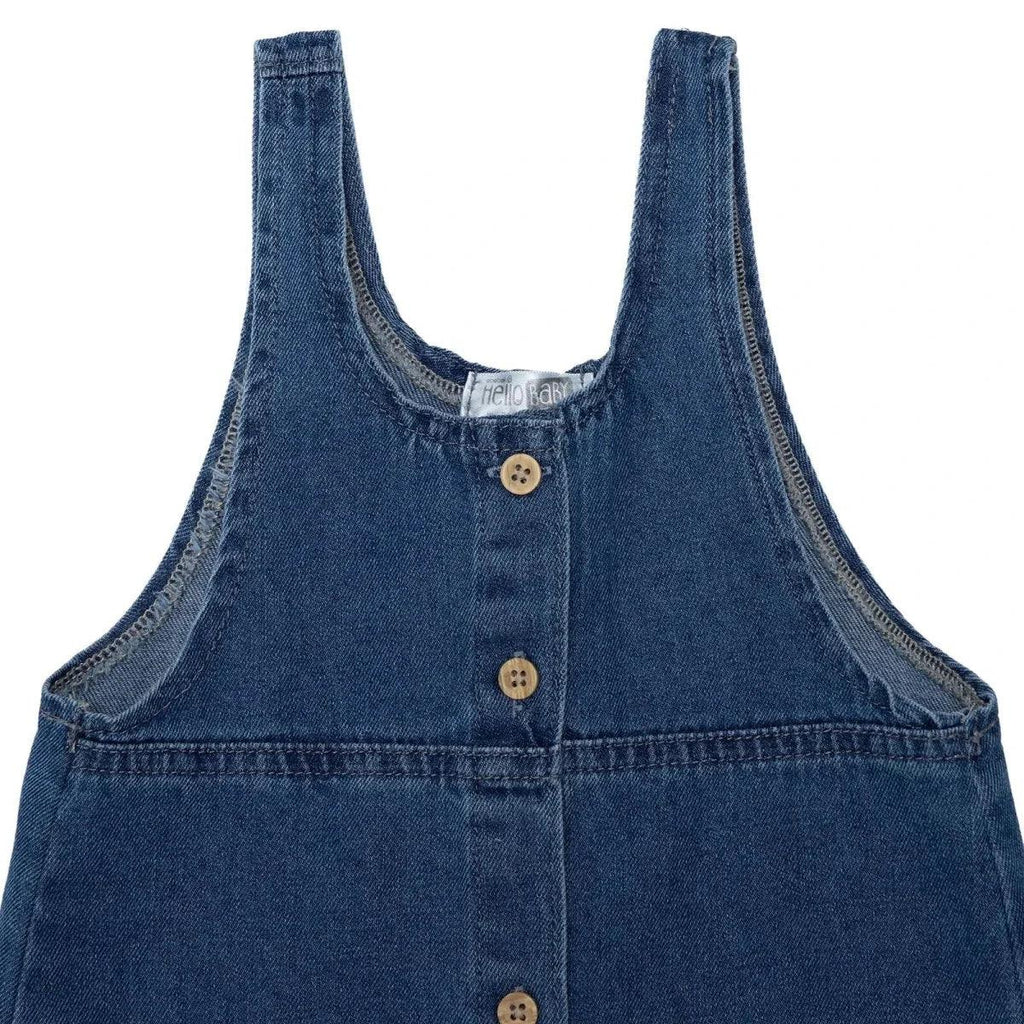 Indigo denim pinafore bib with three wooden-look buttons and contrast stitch trim