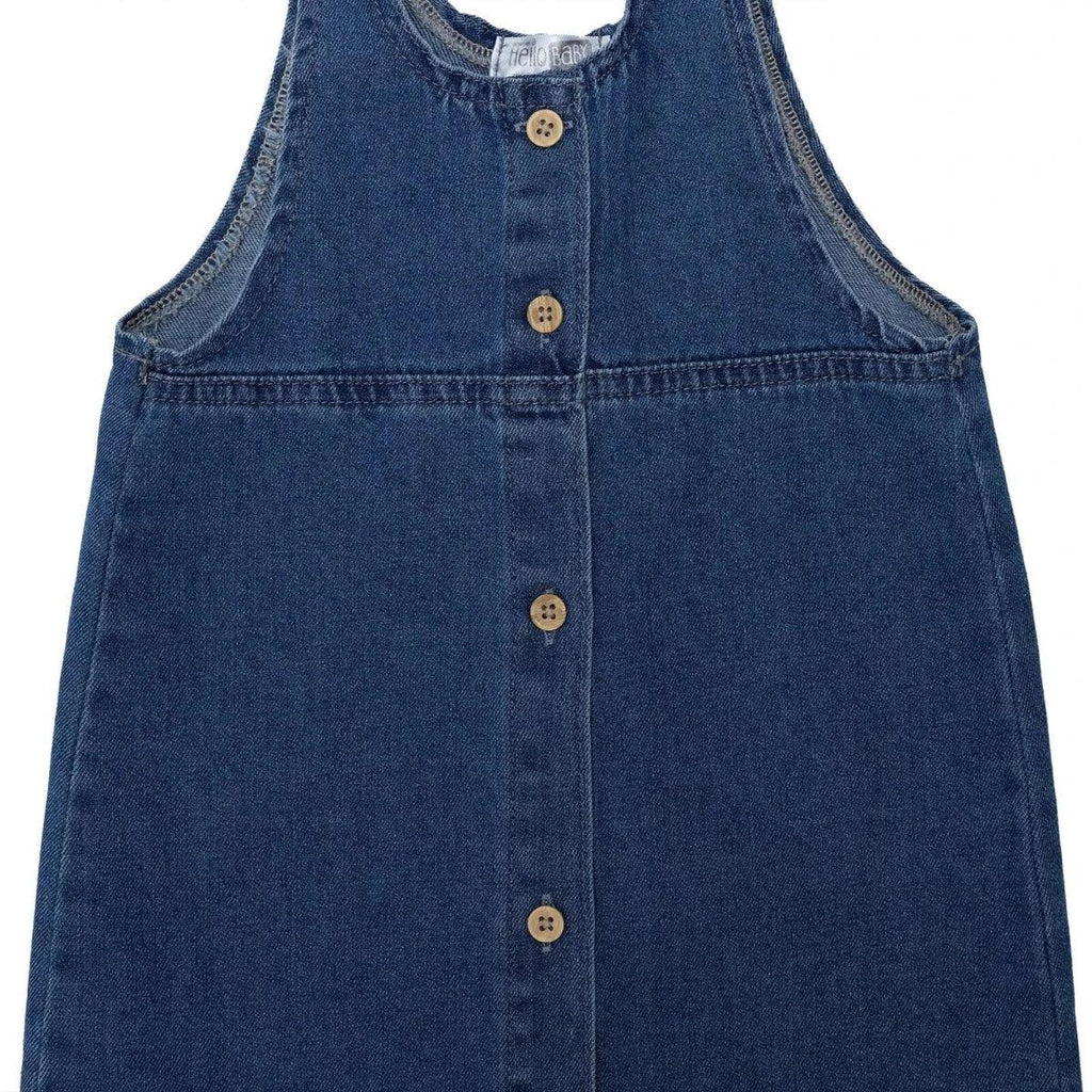 Indigo denim pinafore dress front with central button row and seam details