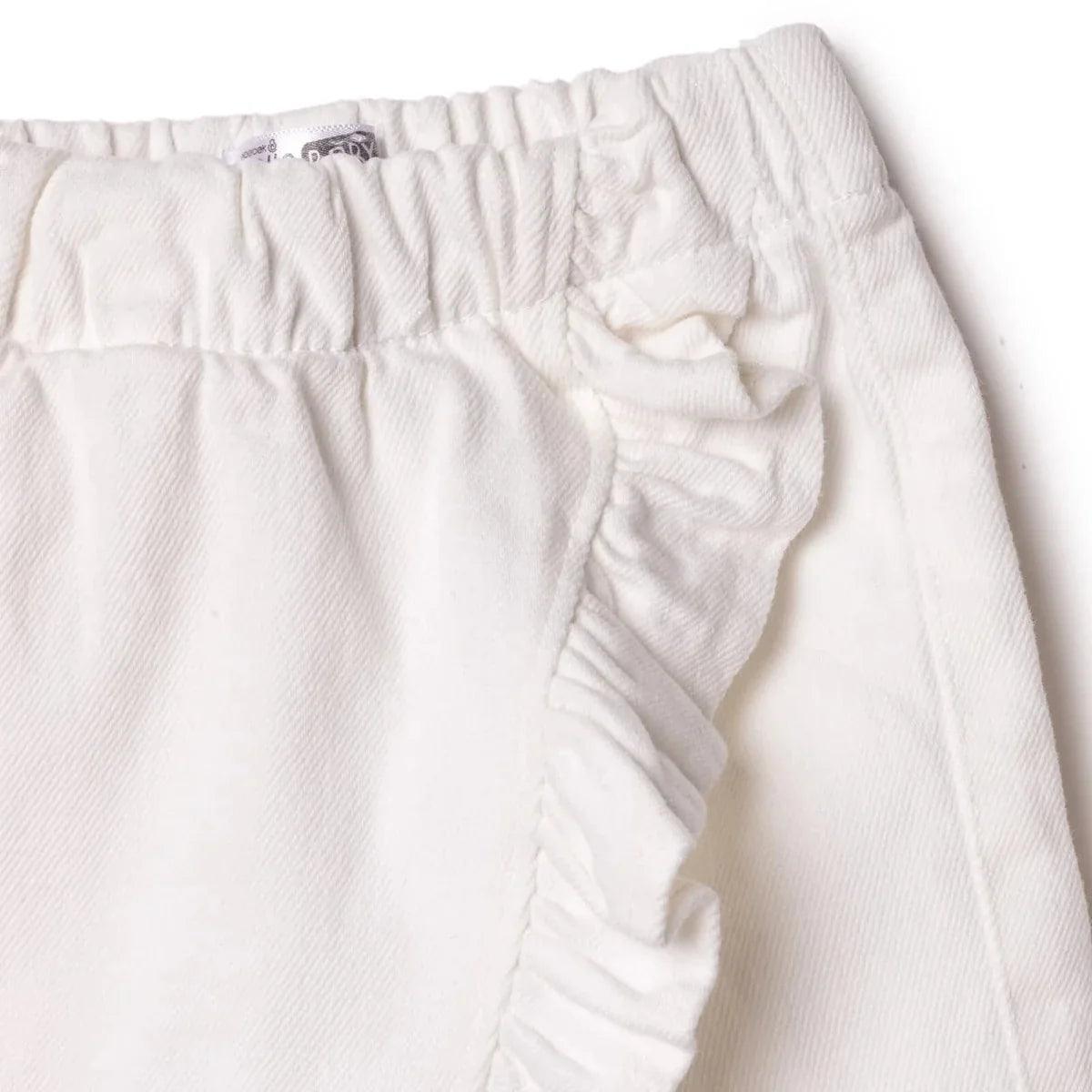 Ecru baby skort close-up of side ruffle trim and gathered skirt overlay