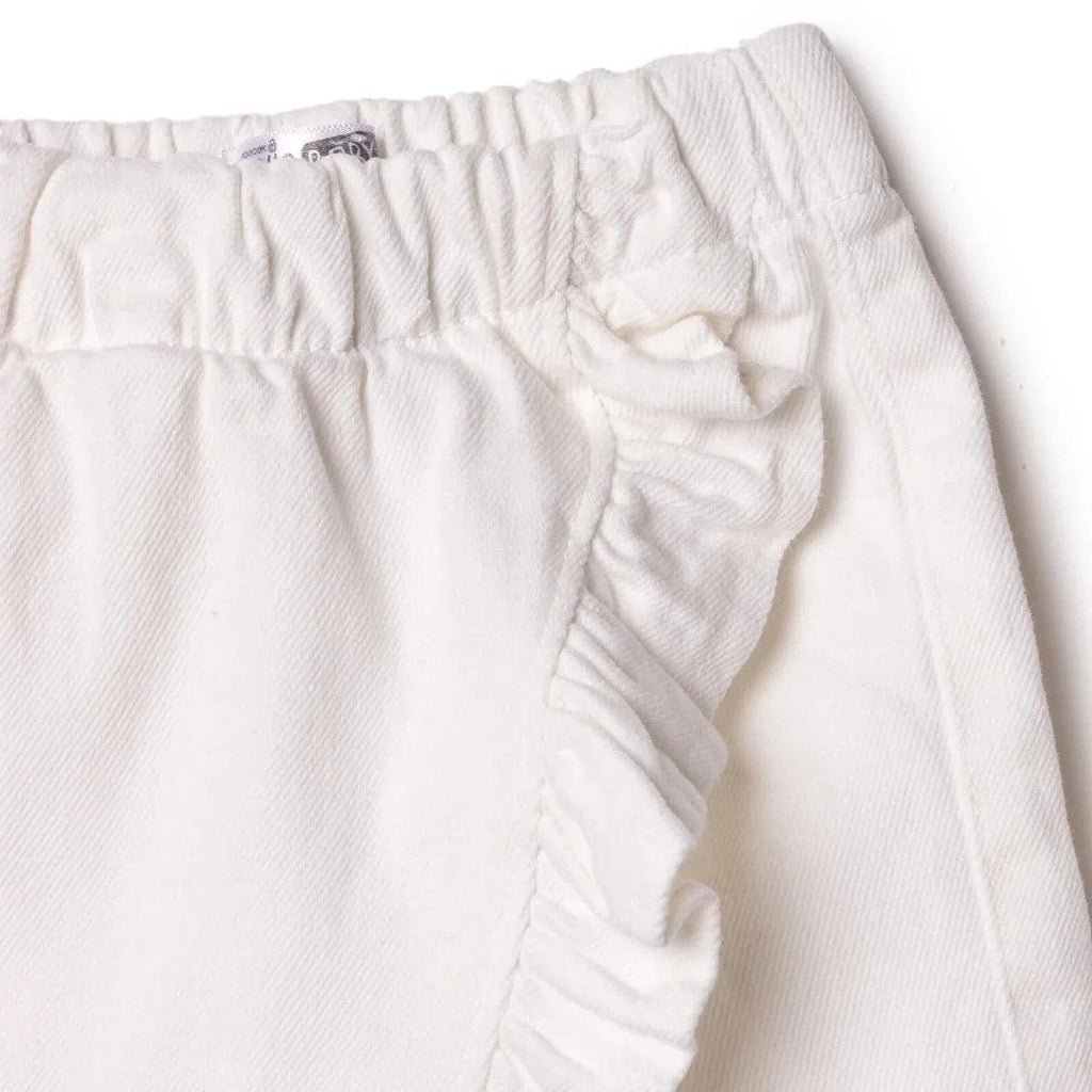 Ecru baby skort close-up of waistband stitching and side ruffle trim