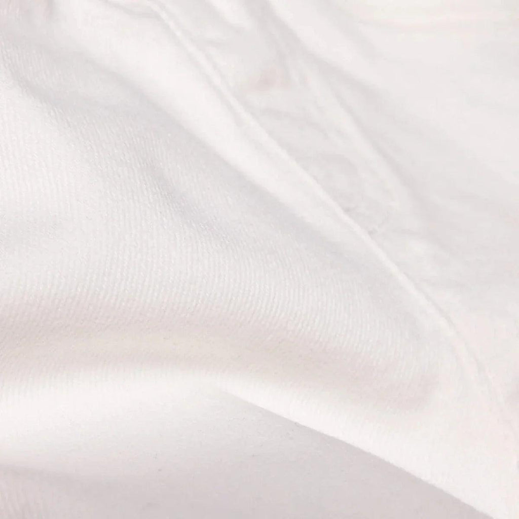 Ecru denim baby shorts fabric close-up with subtle texture