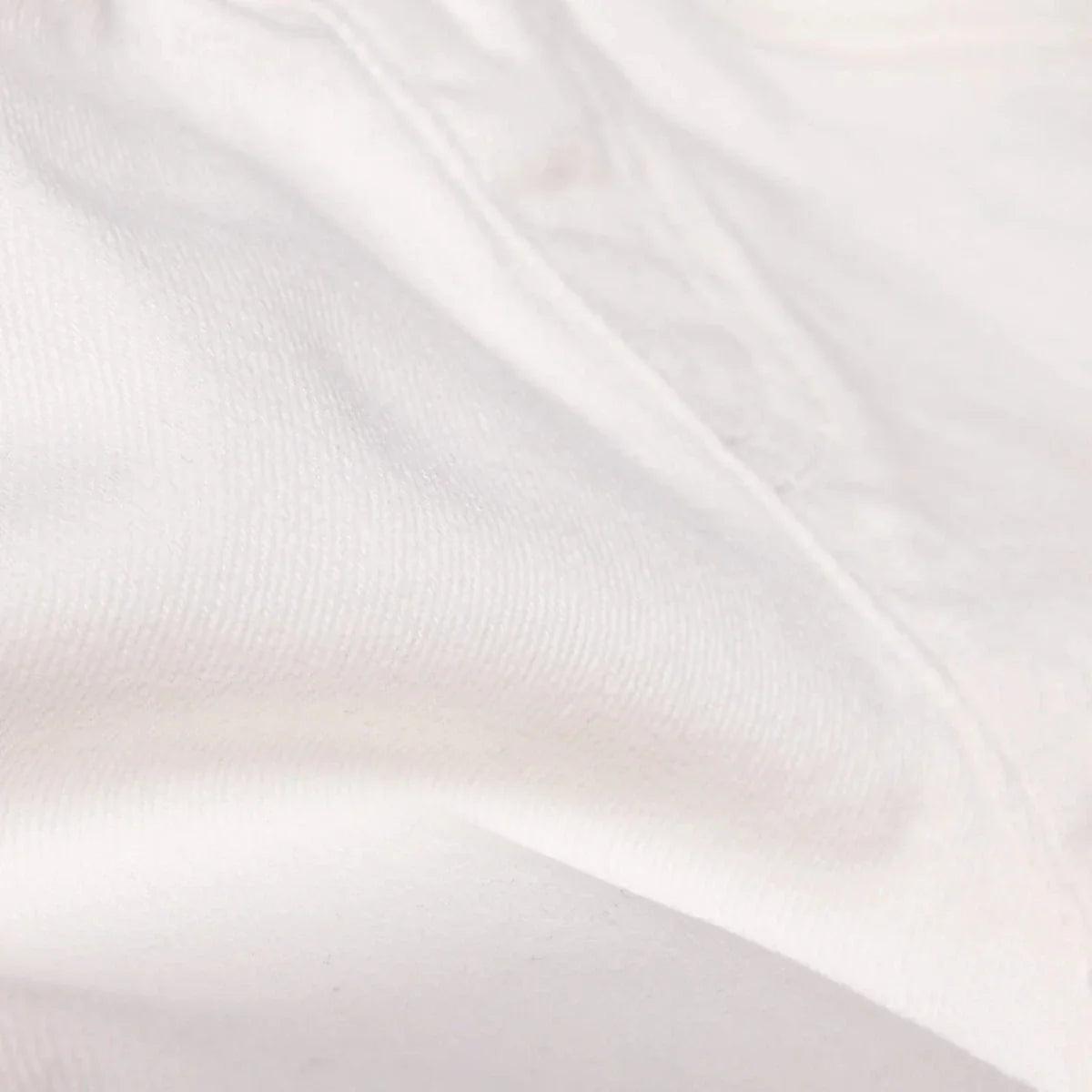 Ecru denim baby shorts fabric close-up with subtle texture