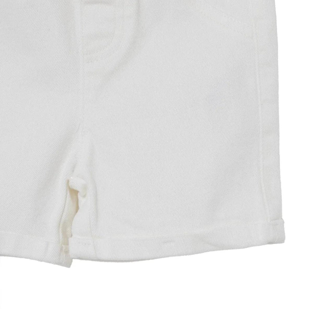 Ecru denim baby shorts, side view with cuffed hem and clean stitching