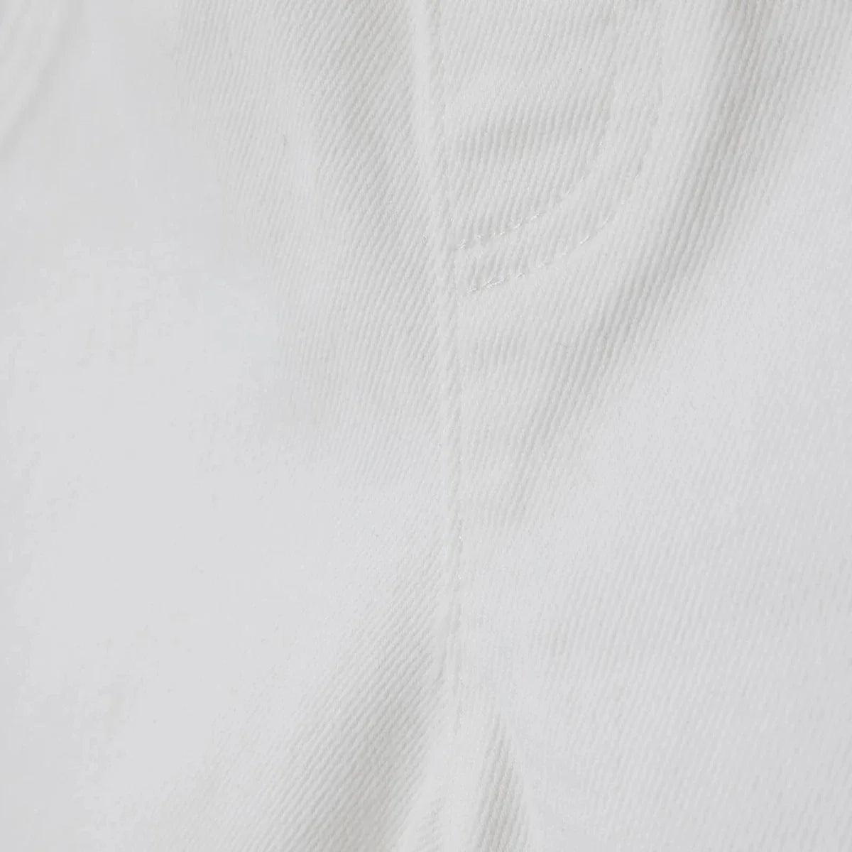 Ecru denim fabric texture close-up on baby shorts