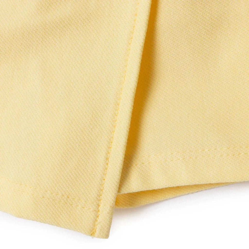 Yellow baby skort side view with stitched seam and hem edge