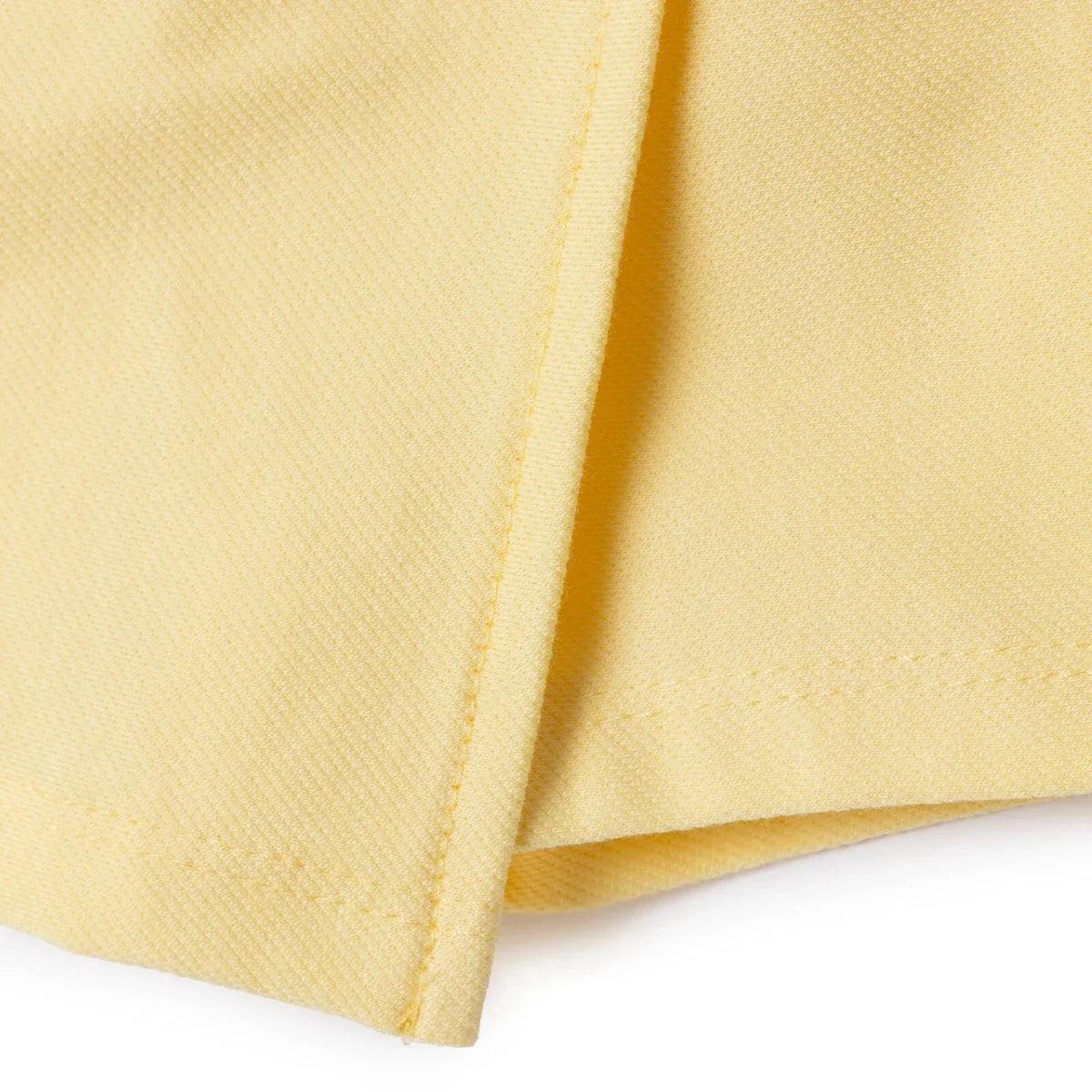 Yellow baby skort side view with stitched seam and hem edge