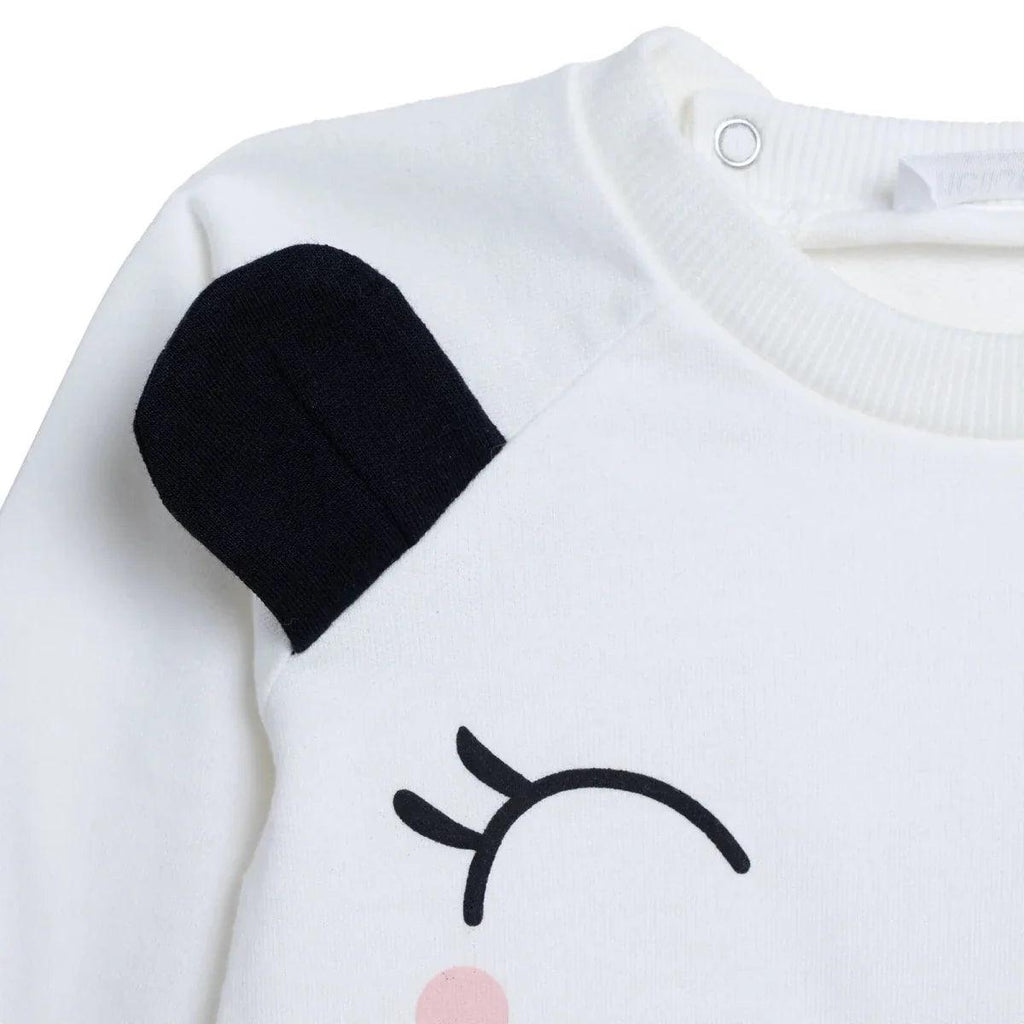 Ecru baby sweatshirt close-up with black ear patch and round snap neckline