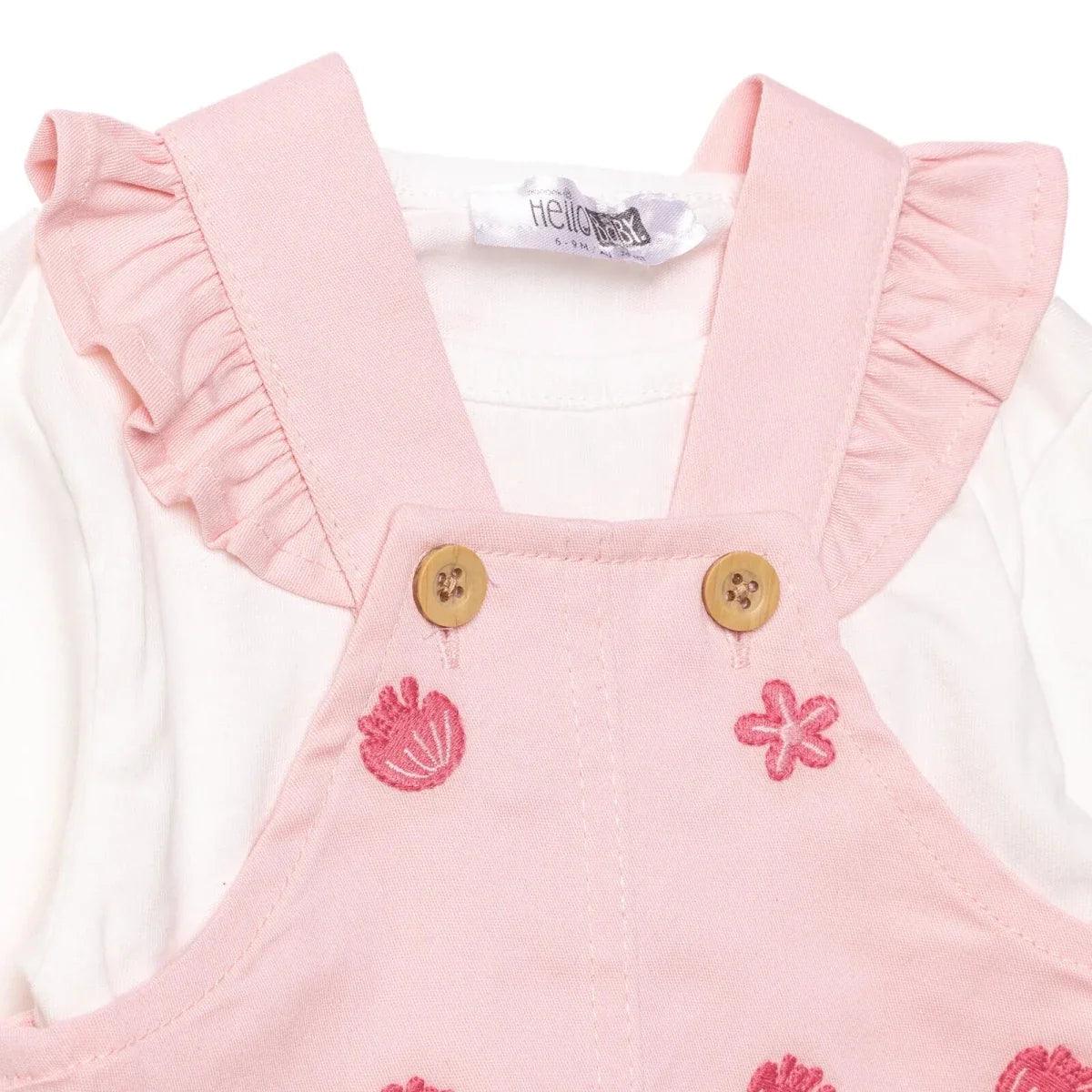 Pink dungarees with ruffled straps, two wooden-style buttons, tulip and flower embroidery