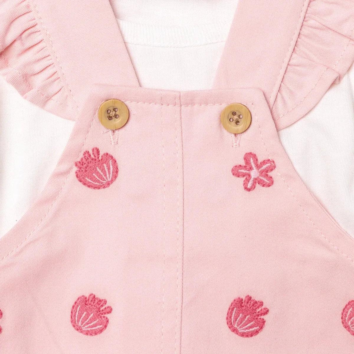 Pink dungarees bib with two buttons and tulip and daisy embroidery