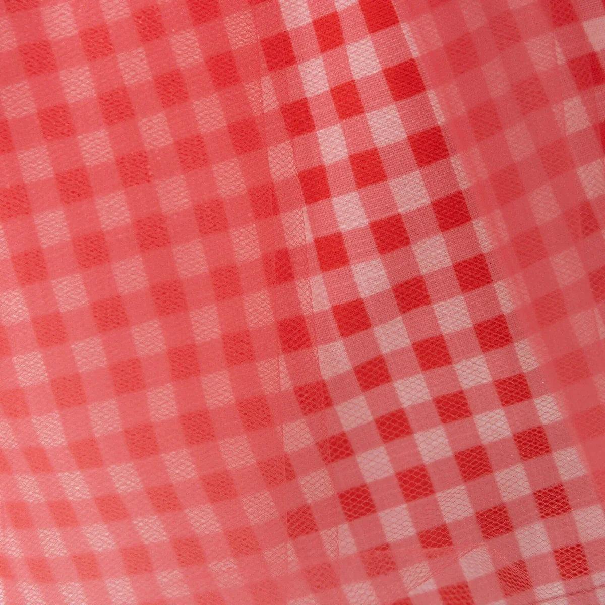 Close-up of red and white gingham check pattern on tulle skirt