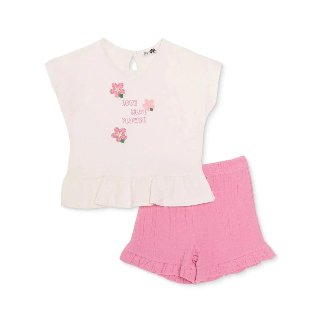 Ecru baby t-shirt and pink shorts set with flower graphic and ruffle hem.