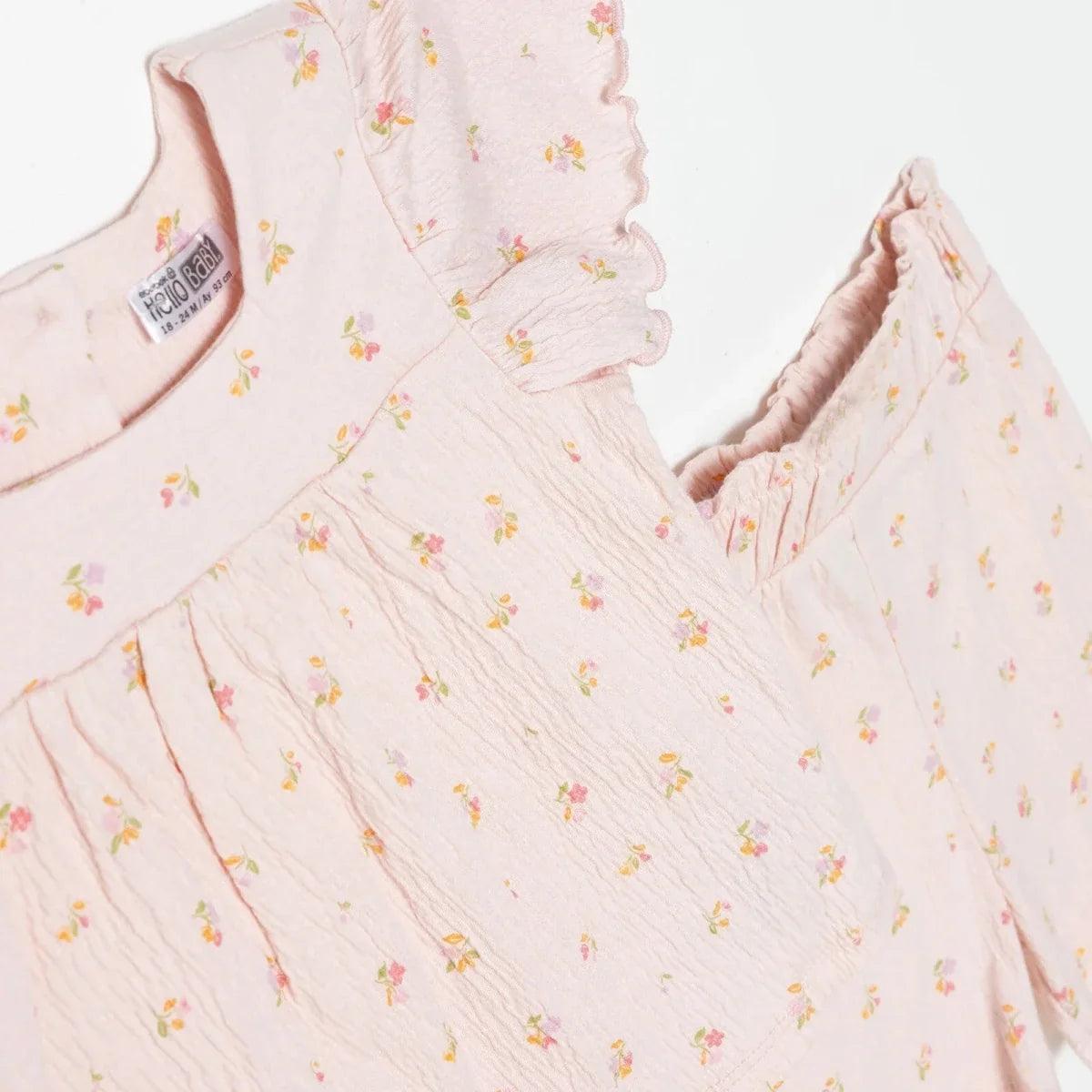 Pink floral baby top close-up, ruffled flutter sleeves and gathered bodice