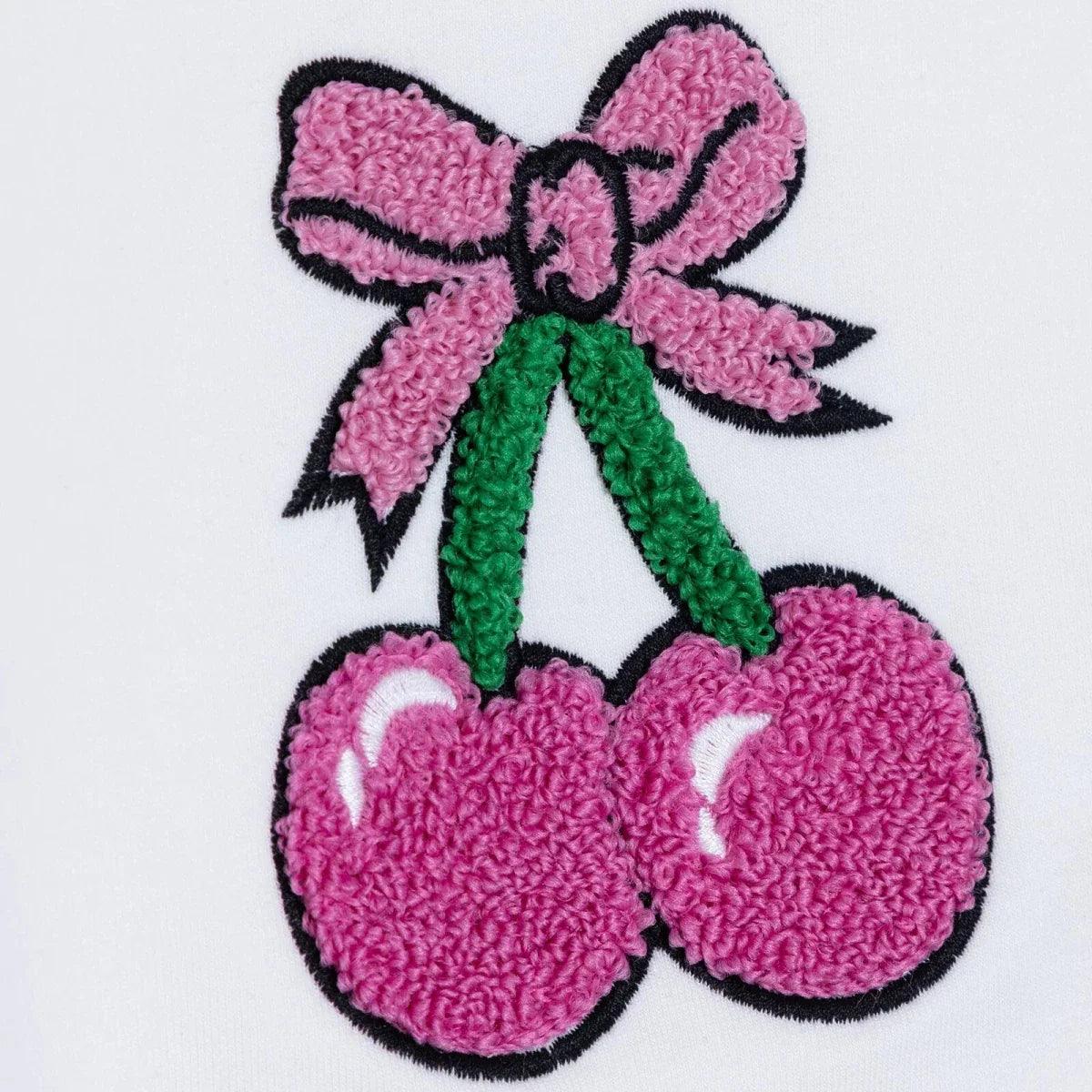 Close-up cherry print applique on white baby sweatshirt, pink cherries with green stems