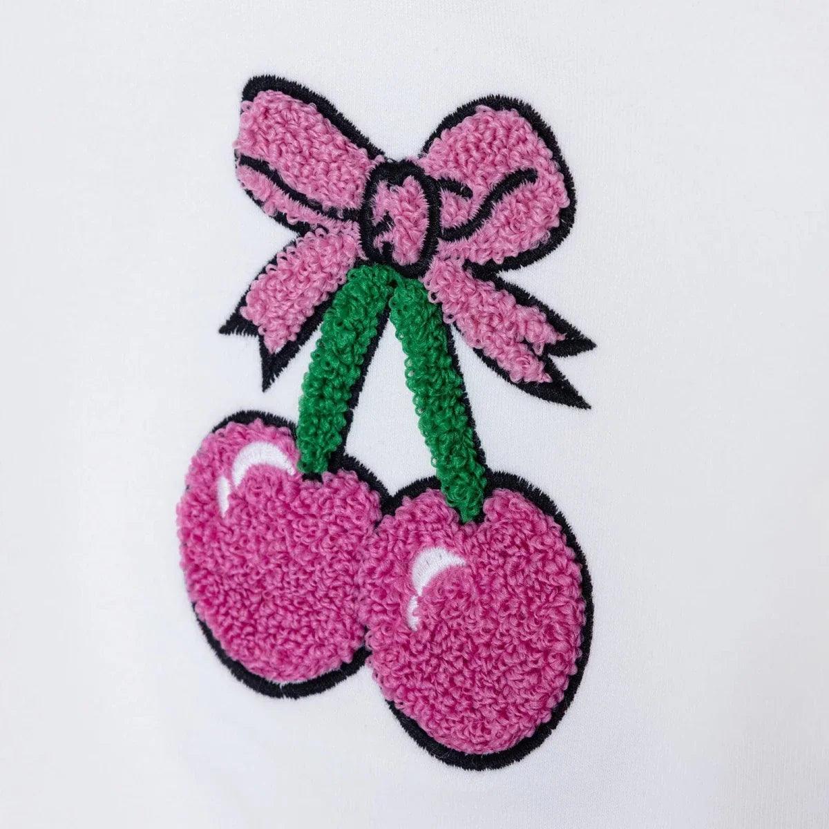 Close-up cherry bow and pink cherries applique on white baby sweatshirt