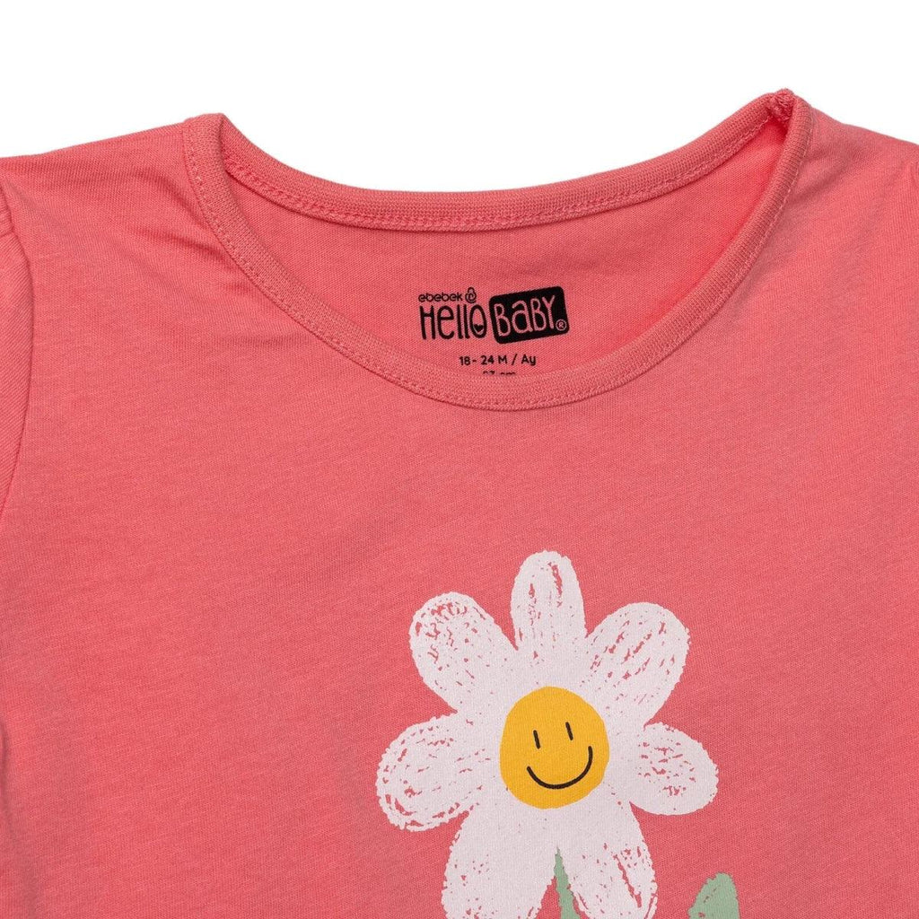 Coral baby T-shirt with HelloBaby neckline label and partial daisy smiley print