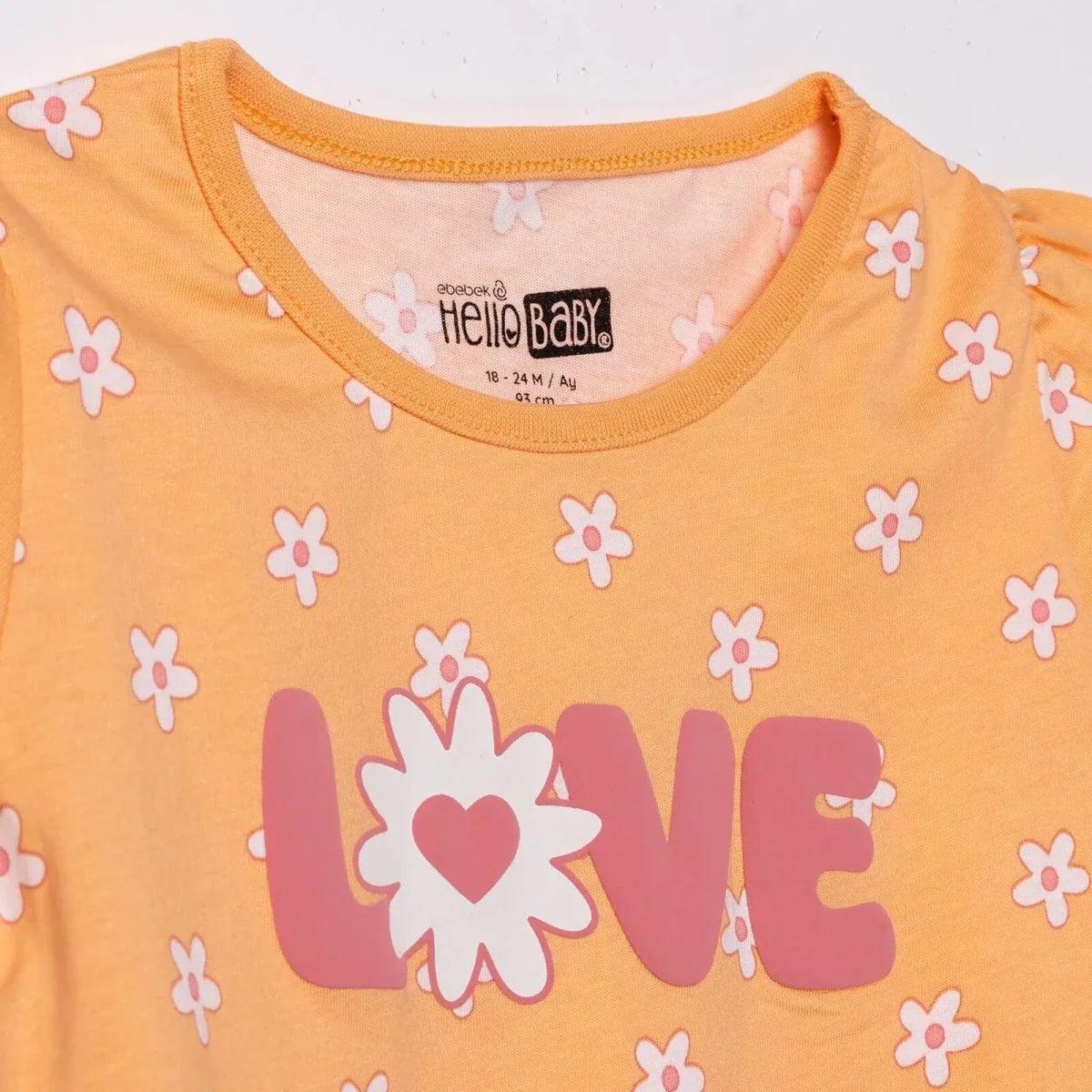 Salmon orange baby jersey T-shirt close-up of LOVE heart graphic and floral print
