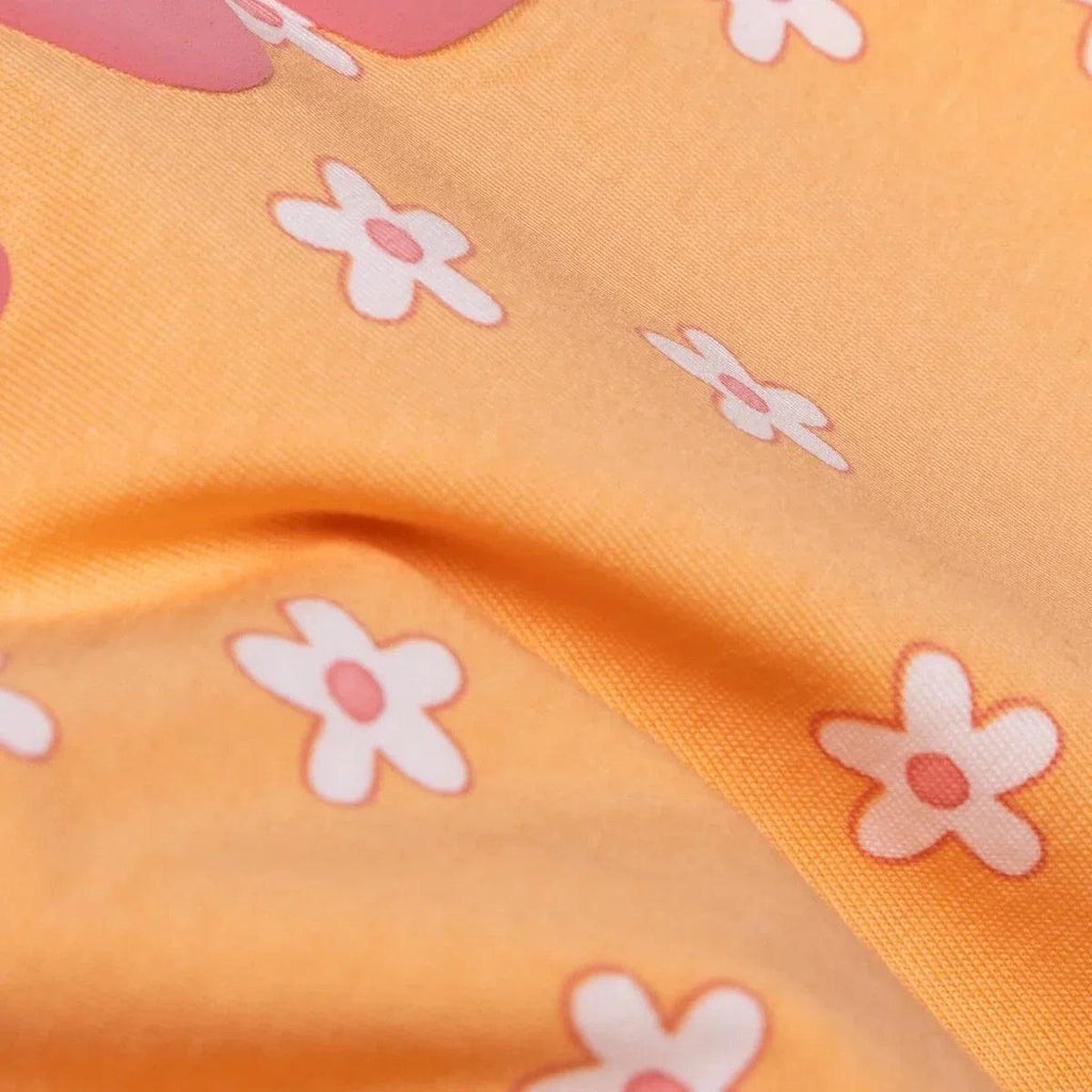 Salmon orange jersey fabric close-up with small flower prints texture