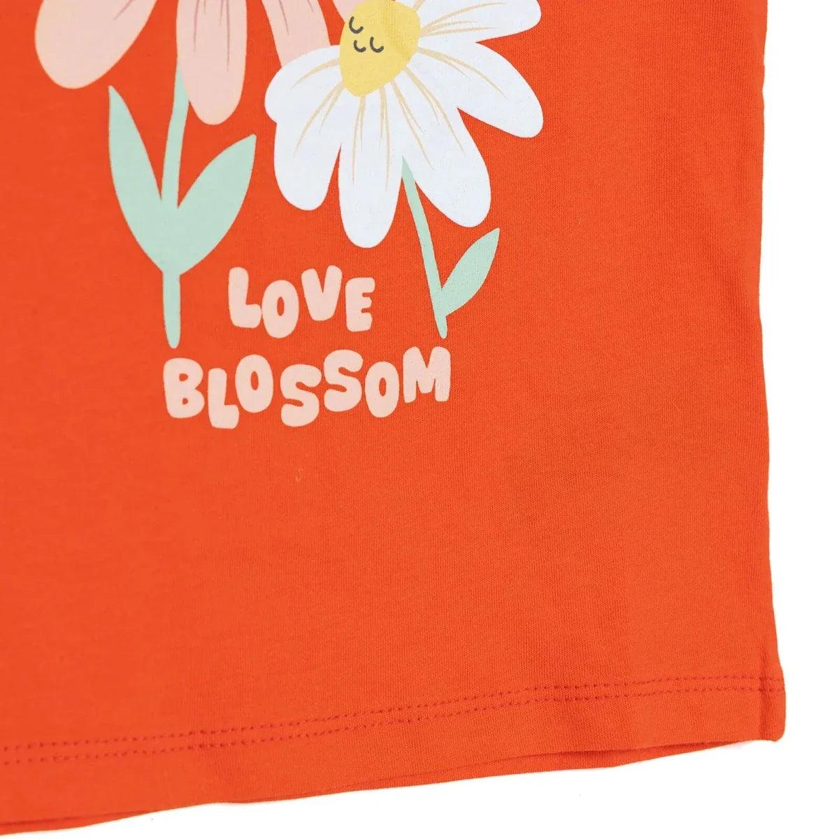 Coral baby jersey T-shirt hem with partial "Love Blossom" daisy graphic